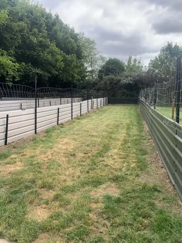 Secure grassy exercise runs with easy access from the kennels.